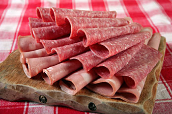 a plate of cold cuts including salami and bologna