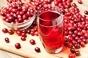 cranberry fruits and a glass of cranberry juice