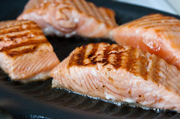 salmon filets roasting on a grill pan