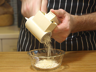 Grate the Parmigiano-Reggiano. My rotary grater makes grating cheese simple and is easy on the hands.