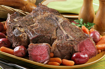 a beef roast with red potatoes and baby carrots