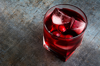 a glass of iced cranberry juice