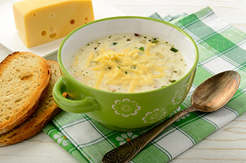 potato soup garnished with cheese and chives