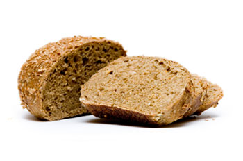 a loaf of whole wheat bread with several slices cut from it