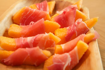 Canteloupe melon slices wrapped with prosciutto