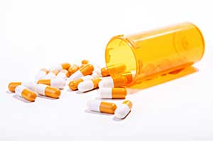 capsules spilling from a prescription bottle