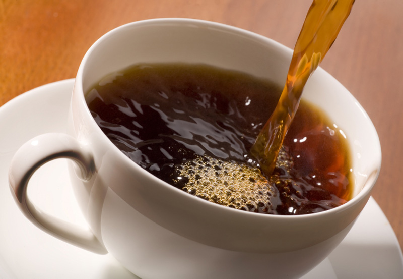 black coffee being poured into a cup